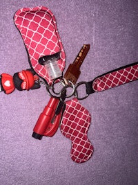 a red key holder with a key ring attached to it