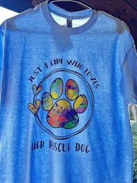 a blue t - shirt with a paw print on it