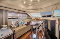 the interior of a motor yacht with a sofa and a table