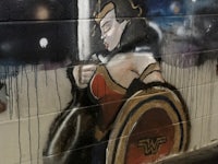 a graffiti painting of wonder woman holding a sword