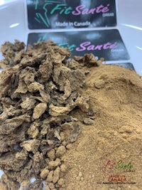 a pile of brown powder next to a label