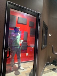 a man standing in front of a door in a recording studio