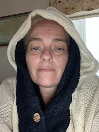 a woman wearing a hooded sweatshirt