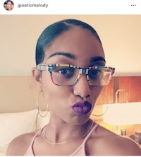 a woman wearing glasses and purple lipstick