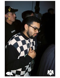 a man wearing glasses and a checkered shirt