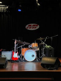 a stage with a drum set and a guitar