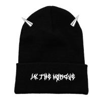 a black beanie with studs on it