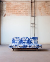 a blue and white sofa in an empty room