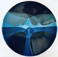 a plate with a blue and black design on it