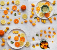four plates with oranges and lemons on them