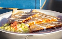 a plate of quesadillas on a table