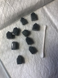 a group of black stones on top of a piece of cloth