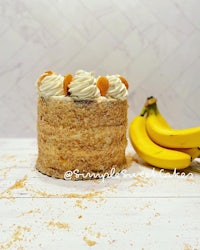 a cake sitting on a table next to bananas