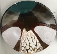 two brown and white plates hanging on a wall
