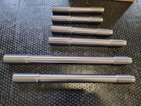 a set of stainless steel rods on a table