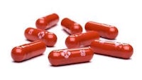 a group of red capsules on a white background