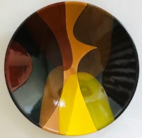 a plate with a black, yellow, and brown design