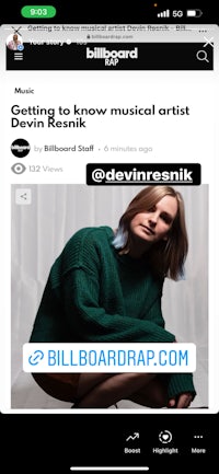 the billboard app with a woman in a green sweater