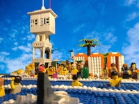 a group of people in legos on a beach