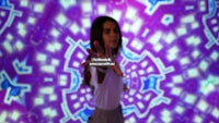 a girl is standing in front of a purple background