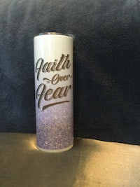 a can with a purple label on it sitting on a table