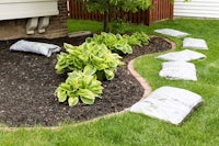a yard with several bags of mulch on the ground