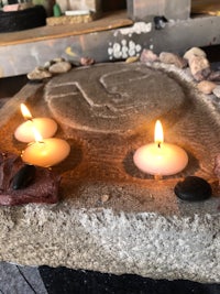 a stone with candles and stones on it