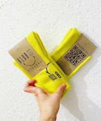 two yellow socks with a qr code on them
