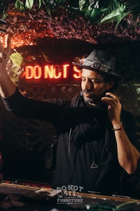 a man in a hat is holding a phone in his hand