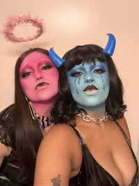 two women posing with makeup on their faces
