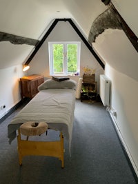 an attic room with a massage table in it