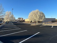 a parking lot with trees in the background