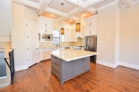 a kitchen with hardwood floors and a center island