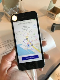 a person holding an iphone with a map on it