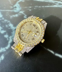 a gold and silver watch with diamonds on it