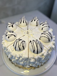 a white cake with chocolate icing on top