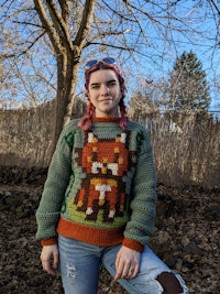 a girl wearing a sweater with a fox on it