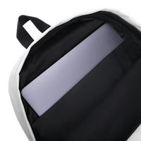 a white and black backpack with a laptop inside