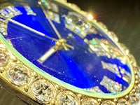 a blue watch with diamonds on it