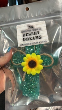 a person holding a bag of desert dreams glitter
