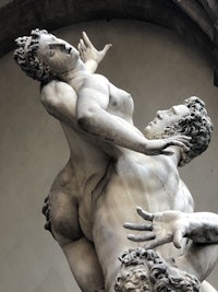a statue of a man and a woman wrestling