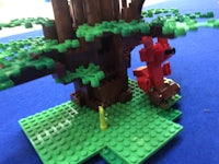 a lego model of a tree with a red lego