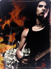 a man is playing a guitar in front of flames