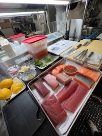 a tray of fish and vegetables on a counter