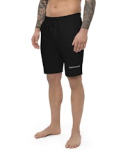 a man wearing black shorts with tattoos and tattoos