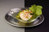 a plate with shrimp and lettuce in it