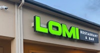 a building with a sign that says lomi restaurant and bar
