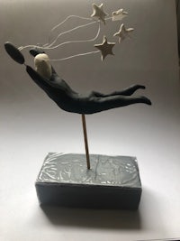 a sculpture of a man flying through the air