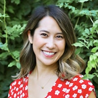 a smiling woman in a red polka dot dress