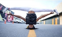 a woman doing a handstand in the street